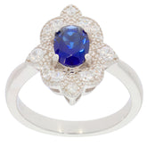Blue sapphire sterling silver ring with accent stones in an elegant floral design, showcasing luxury and sophistication.